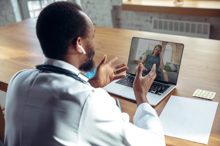 doctor-advising-patient-online-with-laptop